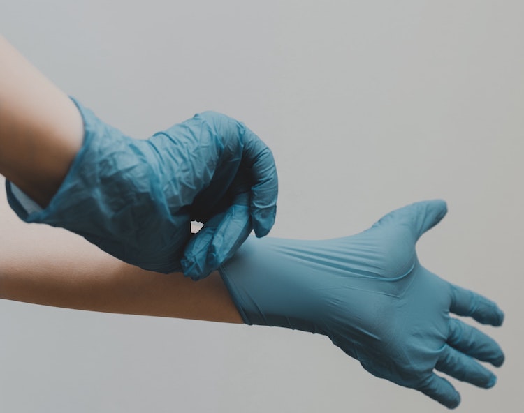 Blue rubber gloves for cleaning home siding