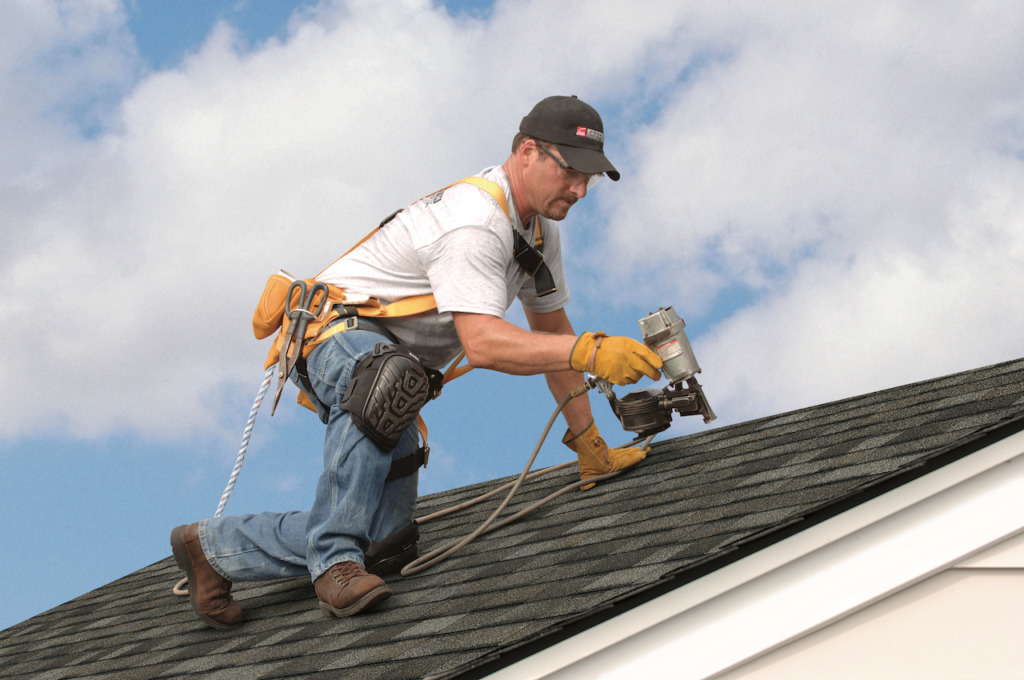 Worker repairing a roof as part of exterior remodeling