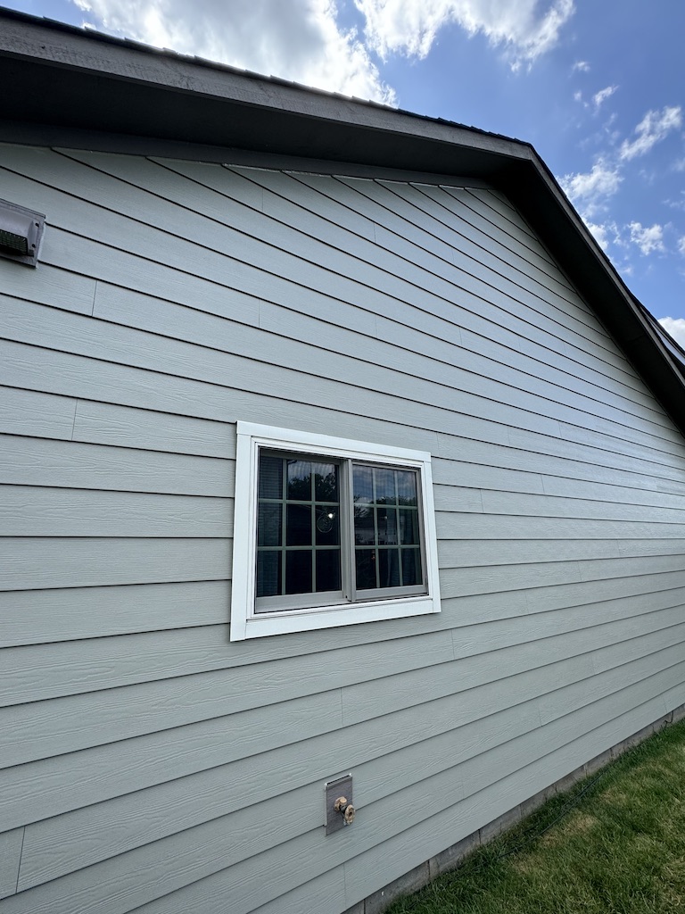 Side window view of the Wise home after a siding replacement